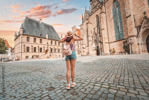 Fototapeta Happy woman tourist with backpack enjoying panorama of the city hall rathaus and