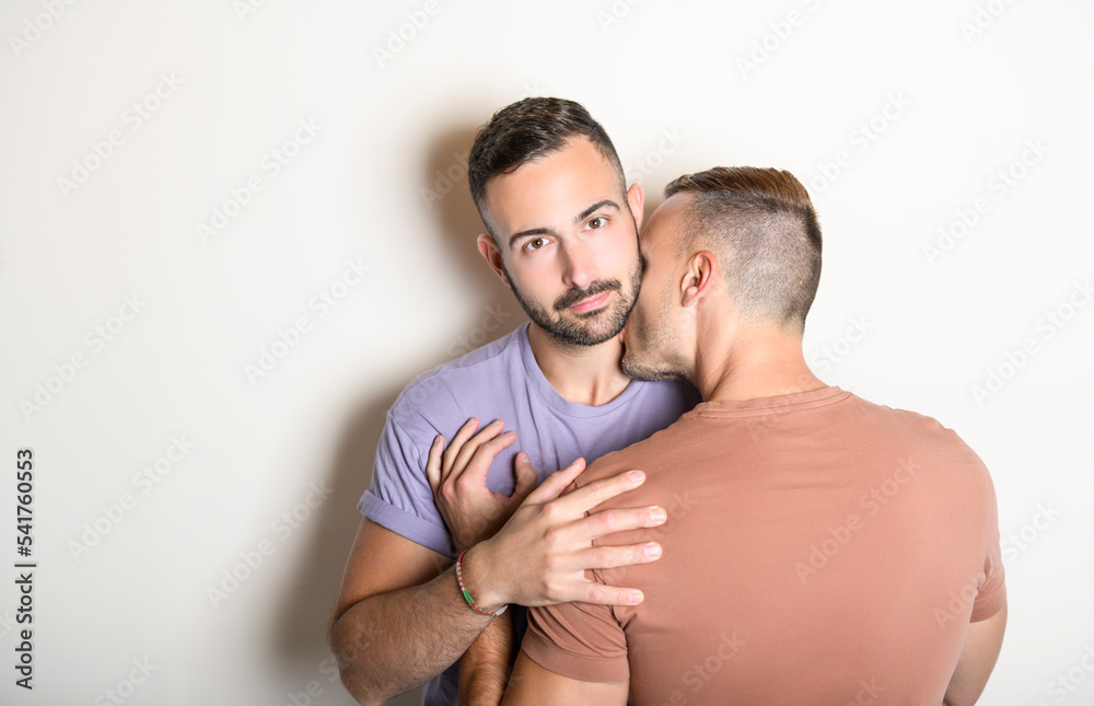Two young men couple over white background on studio Two young men couple over white background on studio