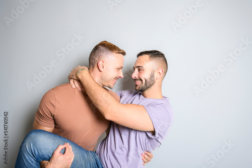 Two young men couple over white background on studio
