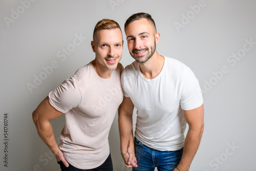 Two young men couple over white background on studio