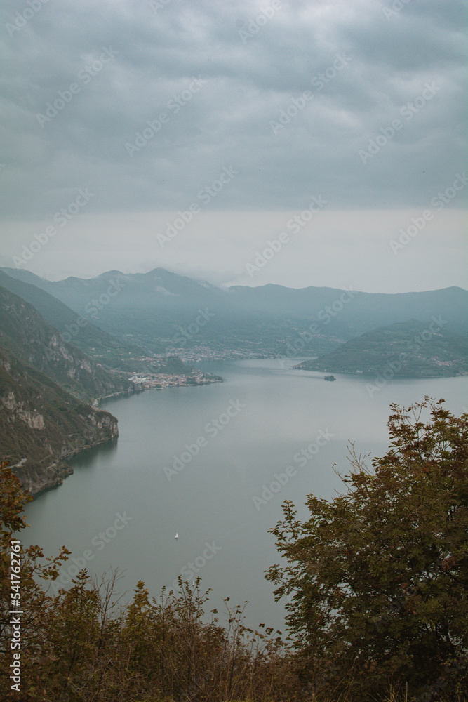 Fototapeta premium medieval town view to Loreto Island with the castle on Lake Iseo in Northern Italy - Stories vertical format and wallpaper, near Brescia and Bergamo cities in autumn