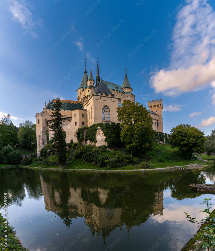 view of the Bojnice Castle with reflections in the moat