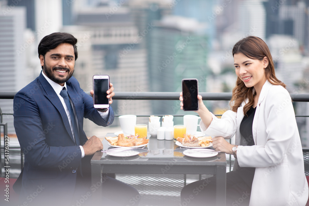 Business meetings for women businessmen and men businessmen in luxury restaurants. show smartphone paying. payment Business meetings for women businessmen and men businessmen in luxury restaurants. show smartphone paying. payment