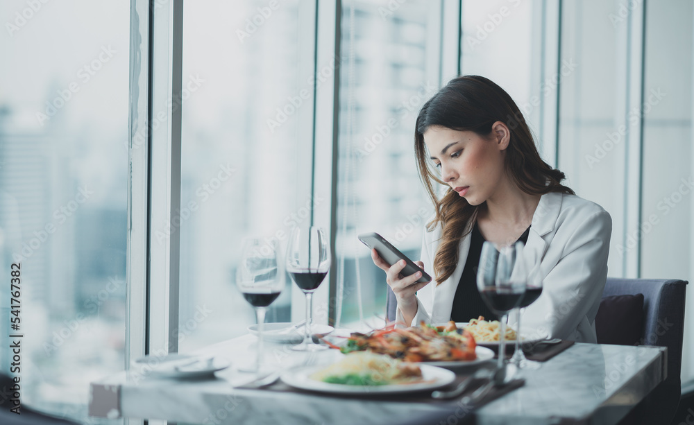 women looking at smartphone waiting for someone women looking at smartphone waiting for someone