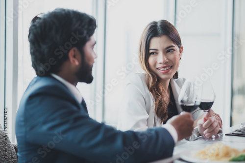 Business meetings for women businessmen and men businessmen in luxury restaurants.Beautiful women talk happily with men.men and women drink wine together happily