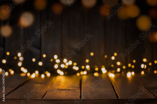 Festive background of dark brown table top with lights bokeh. Copy space, space for products display