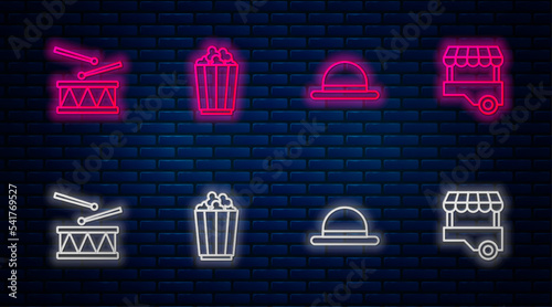 Set line Popcorn in box, Clown hat, Drum with drum sticks and Fast street food cart. Glowing neon icon on brick wall. Vector