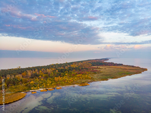 drone view of a colourful autumn sunset over the hel peninsula  the baltic sea and the gulf of puck  colourful autumn leaves on the trees