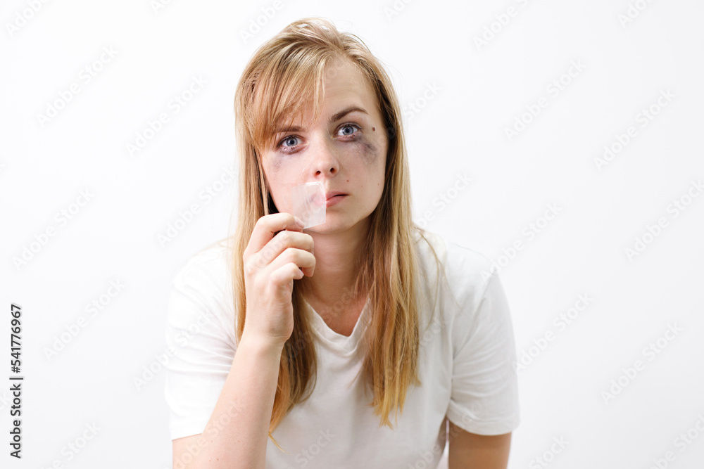 a depressed woman cries and tears tape from her mouth. abuse, freedom of speech, judgment a depressed woman cries and tears tape from her mouth. abuse, freedom of speech, judgment