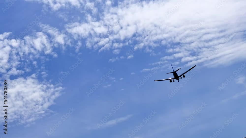 Airplane gaining height after taking off with a blue sky and clouds background Airplane gaining height after taking off with a blue sky and clouds background