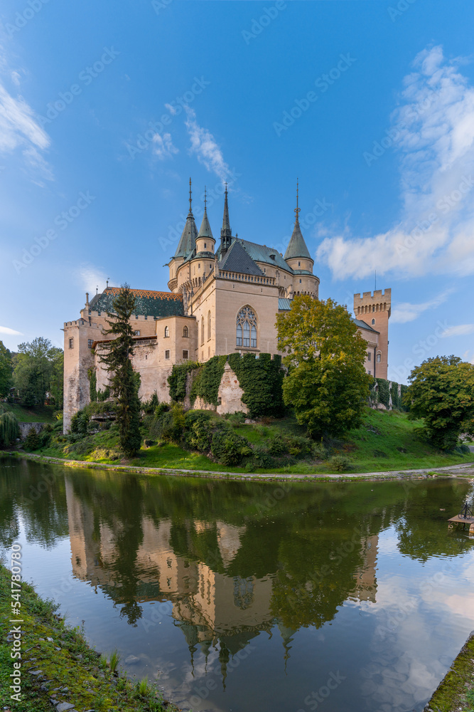 view of the Bojnice Castle with reflections in the moat