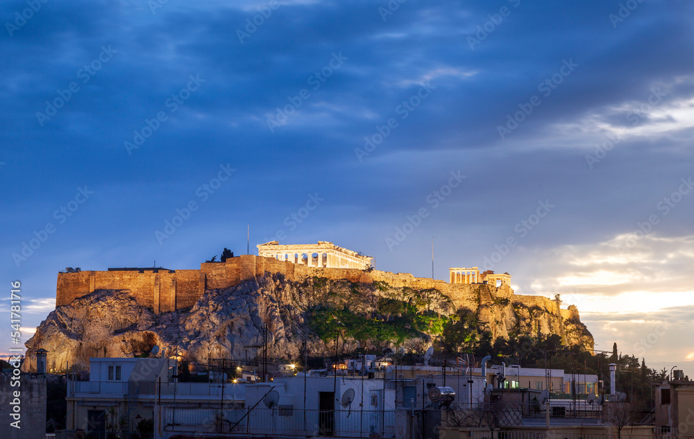Amazing sunset view of the Acropolis and the ancient Parthenon temple, with urban foreground, in Athens, Greece, Europe. 