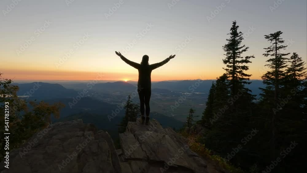 Adventurous Woman Hiking in Canadian Landscape with Fall Colors during sunny Sunset. Elk Mountain, Chilliwack, East of Vancouver, British Columbia, Canada. Adventure Travel Concept. Slow Motion Adventurous Woman Hiking in Canadian Landscape with Fall Colors during sunny Sunset. Elk Mountain, Chilliwack, East of Vancouver, British Columbia, Canada. Adventure Travel Concept. Slow Motion