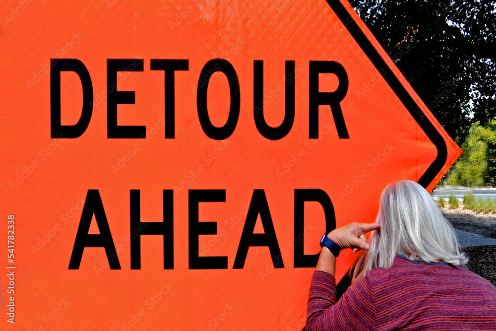 a-play-on-words-detour-a-head-with-person-pointing-at-her-head-a