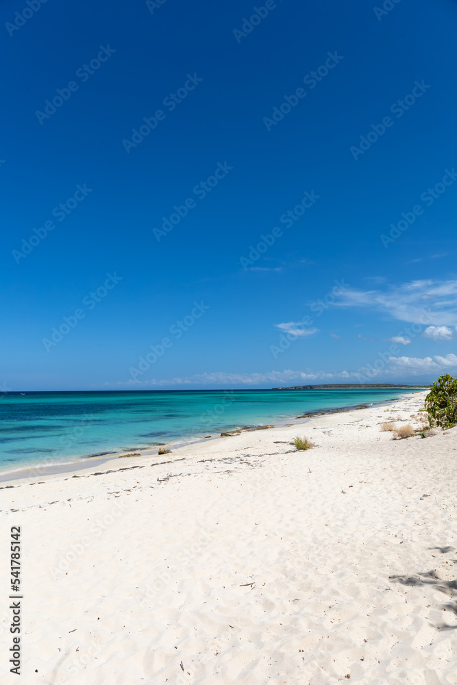 Pristine white sands and crystal clear waters of the Playa de la Cueva Beach, Cabo Rojo, Pedernales, Dominican Republic. Vibrant colors, amazing sea near the border with Haiti.