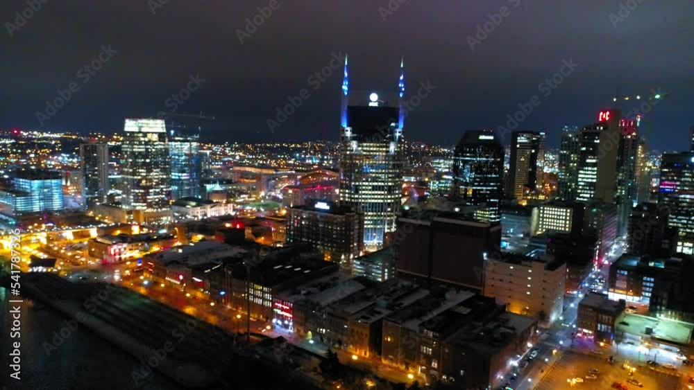 Aerial Shot Of Famous Batman Building In City, Drone Flying Backwards Over Cumberland River At Night - Nashville, Tennessee Aerial Shot Of Famous Batman Building In City, Drone Flying Backwards Over Cumberland River At Night - Nashville, Tennessee