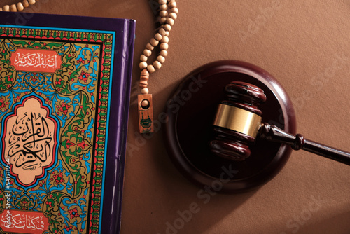 sharia law gavel hammer prayer beads and holy koran book photo
