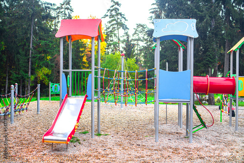 Colourful modern kids playground on the sunset.