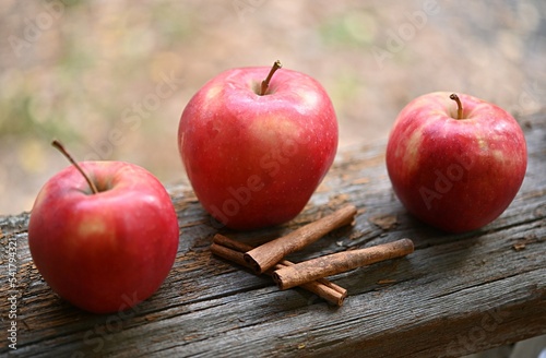 apples with cinnamon on a wooden surface. the concept of healthy food, diet