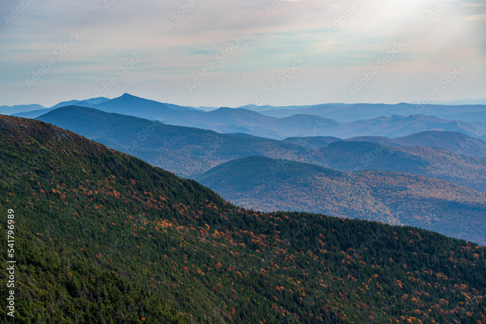 Fototapeta premium Receding summits of the Green Mountains to Camels Hump in the distance from Mount Mansfield
