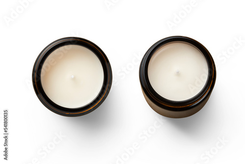 two unused white hand-poured soy wax scented candles in brown glass jars - isolated design elements for cozy or holiday scenes as well as self care themed designs, top view / flat lay