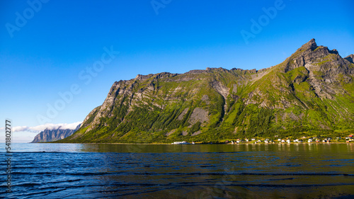 landscape of the island of senja in northern norway, mighty mountains and cliffs above the sea, fjords with breathtaking views