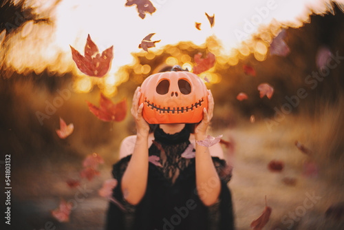 girl holding pumpkin halloween art. photo