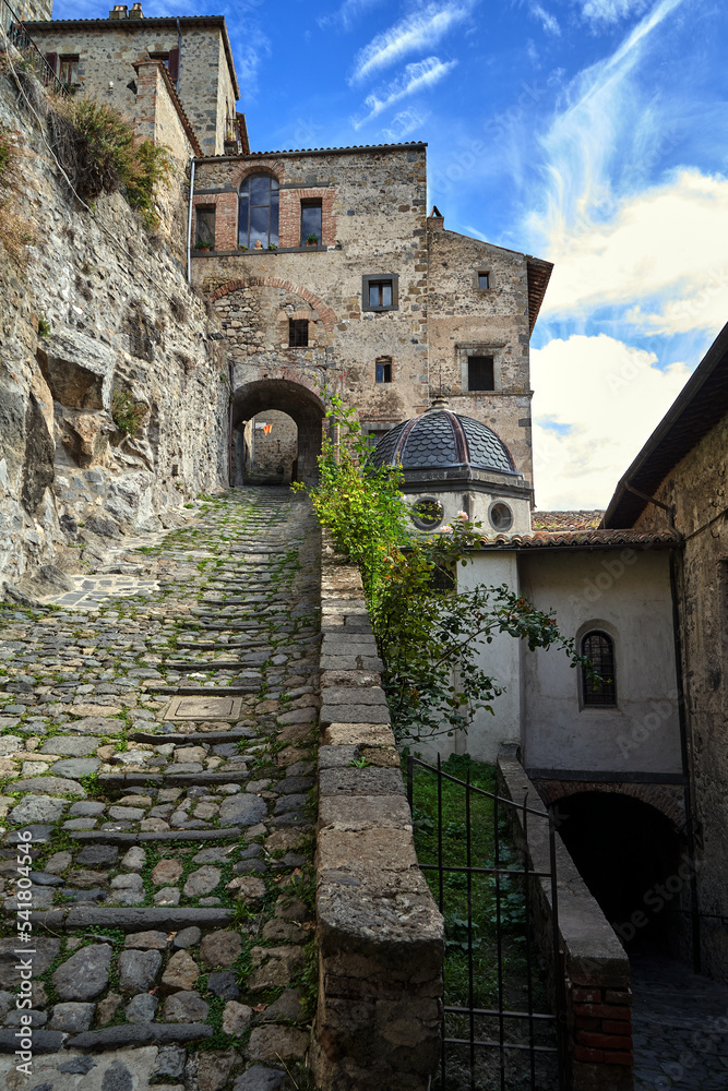 Street with stone steps and a gate in Bolsena