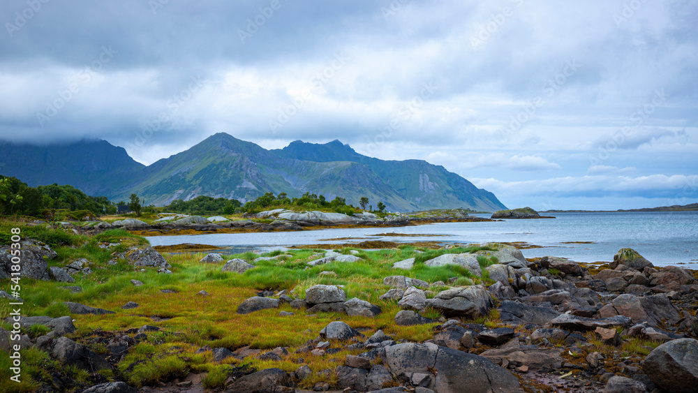 panorama of lofoten islands in northern norway; rugged norwegian fjords; mighty mountains hidden in the clouds, norwegian coastline