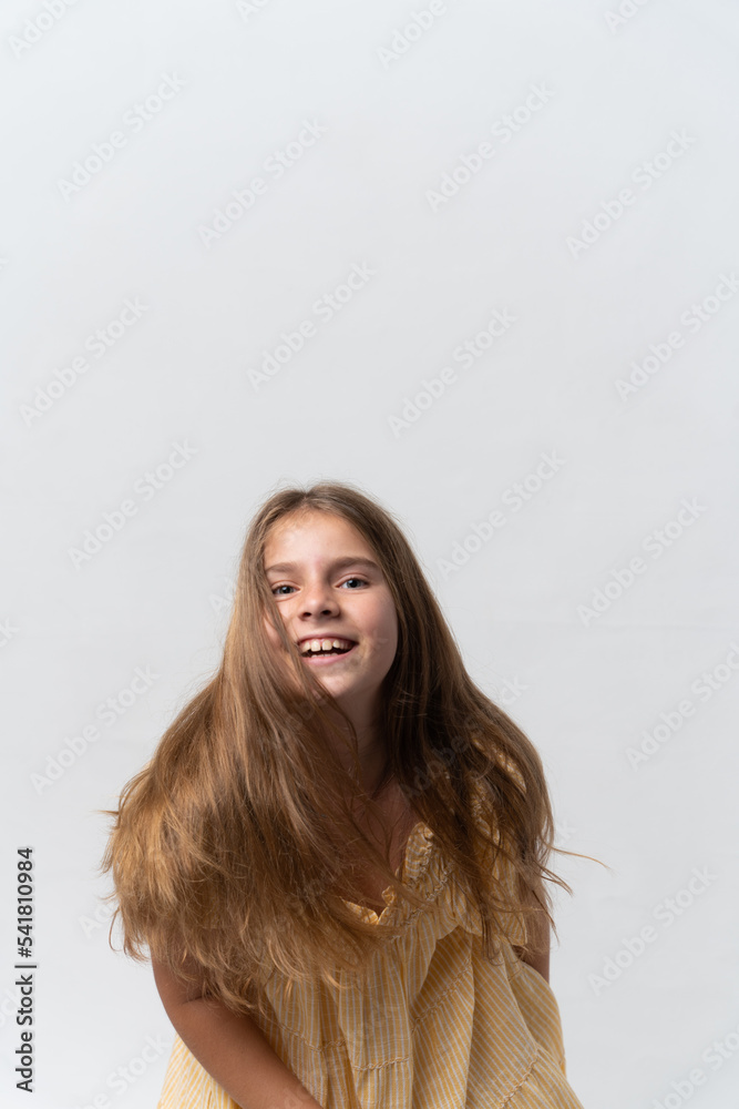 Girl in yellow dress with happy face expression Girl in yellow dress with happy face expression