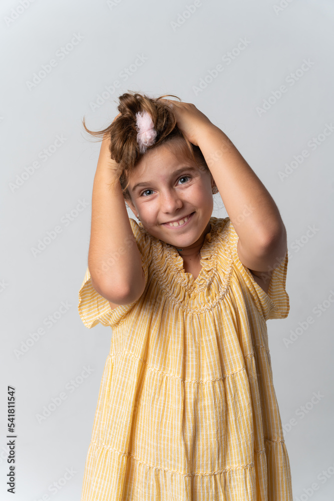 Girl wearing a yellow dress with happy face expression Stock Photo ...