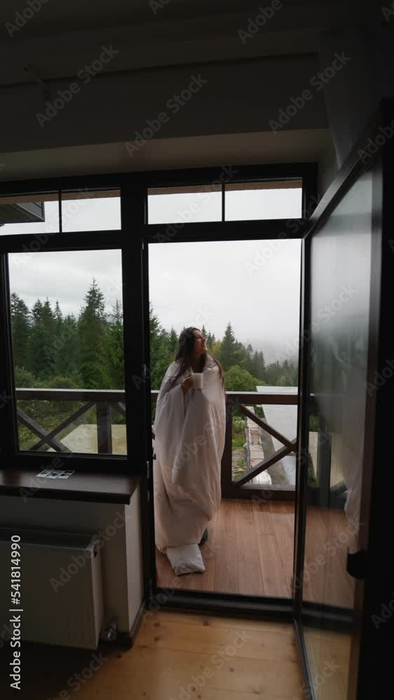 Woman drinking tea on cozy balcony of a country house. Woman drinking tea on cozy balcony of a country house.