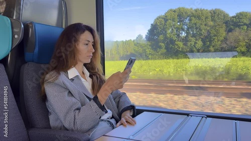 Wallpaper Mural Beautiful female sitting in train, relaxing and using smartphone. Creative girl checking social media, chatting with friends, browsing internet Torontodigital.ca