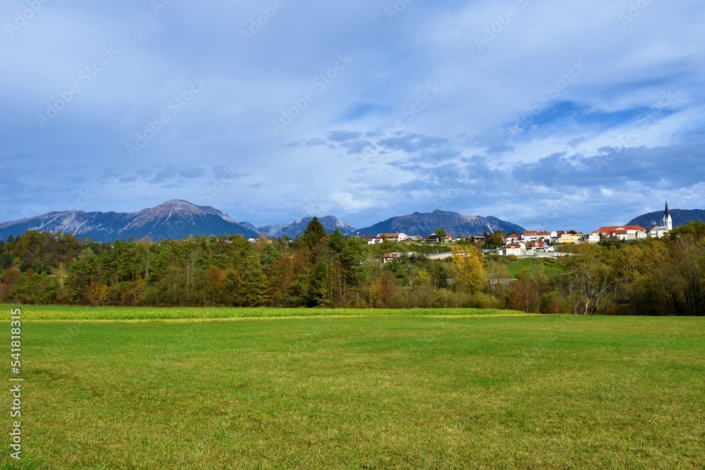 Scenic view of Karavanke mountains and the town of Radovljica above a green field in Gorenjska, Slovenia Scenic view of Karavanke mountains and the town of Radovljica above a green field in Gorenjska, Slovenia