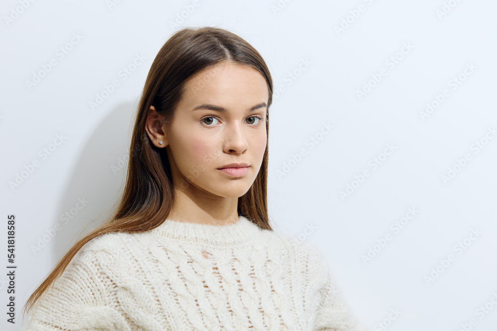 horizontal studio photography on a light background of a beautiful, attractive woman in a stylish sweater looking at the camera horizontal studio photography on a light background of a beautiful, attractive woman in a stylish sweater looking at the camera