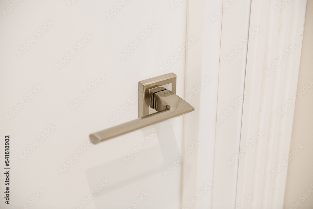 metal handle on a white door in a new house
