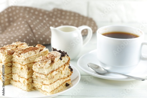 Tiramisu, coffee with milk. Sweet delicious food. Classic tiramisu dessert with cup of coffee and milk photo