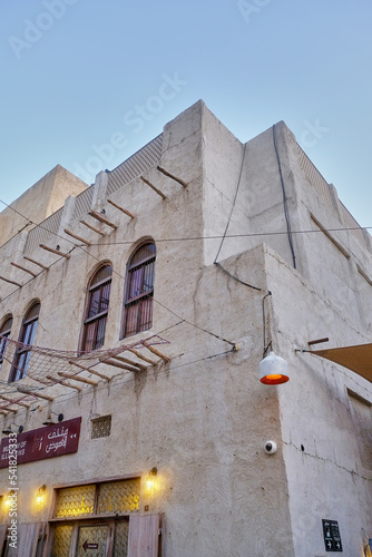 Old Dubai buildings and traditional Arabian street. Museum of illusions, Historical Al Fahidi neighbourhood, Al Bastakiya. Heritage district in United Arab Emirates. photo