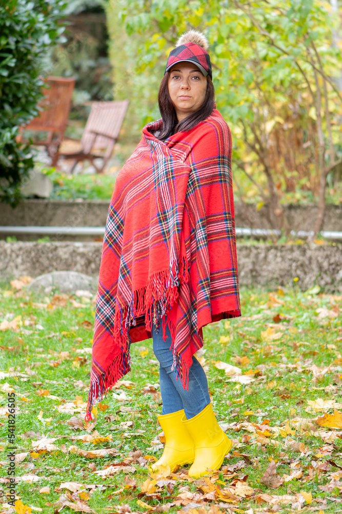 Street portrait of a stylish 4045 year old woman wearing a red plaid