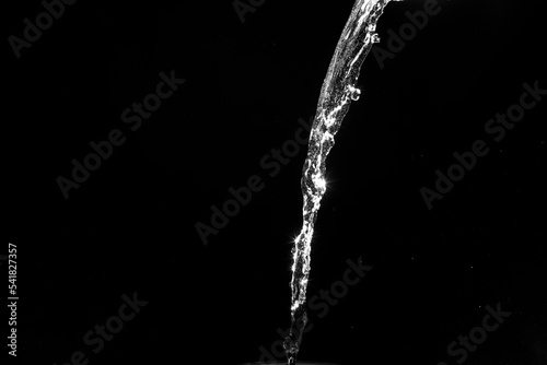 water splashes isolated on black background. white jets with drops
