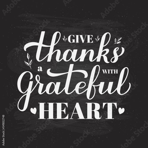 Give thanks with a grateful heart calligraphy hand lettering on chalkboard background. Thanksgiving Day inspirational quote. Vector template for greeting card, typography poster, banner, flyer, etc