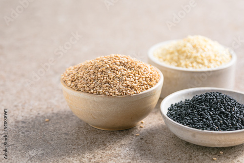 Set with different sesame seeds on stone background. top view.