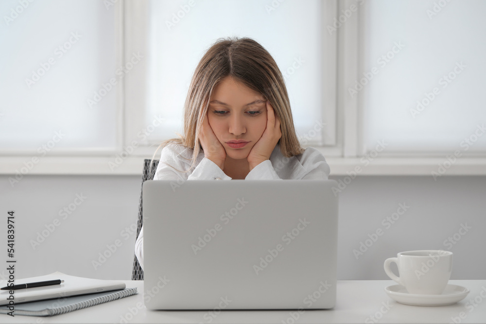 Sleepy young woman at workplace in office Sleepy young woman at workplace in office
