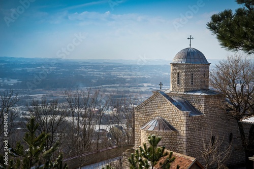 Beautiful view of the Beska Monastery in Zdrelo, Serbia overlooking vast fields under a blue sky photo