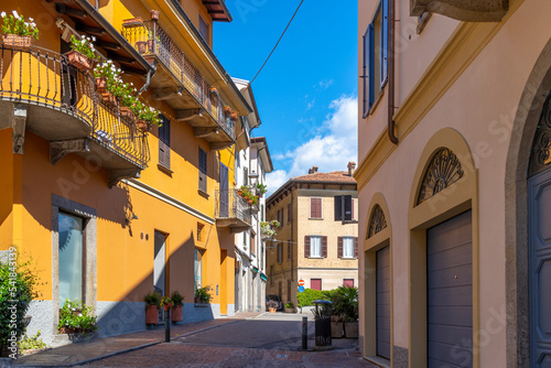 Fototapeta Naklejka Na Ścianę i Meble -  A colorful street of shops and cafes in the historic center of the lakefront town of Menaggio, Italy, on the shores of Lake Como.
