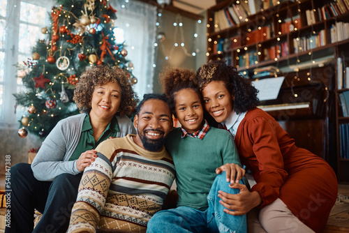 Portrait of happy black extended family on Christmas day at home looking at camera.