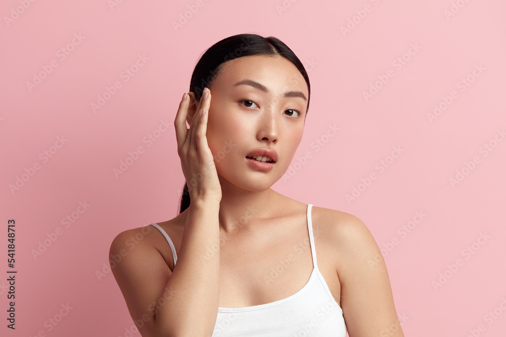 Tender Woman Touching Chick. Portrait of Positive Asian Woman Touching her Face and Smiling. Woman Appearance and Skin Care Concept Tender Woman Touching Chick. Portrait of Positive Asian Woman Touching her Face and Smiling. Woman Appearance and Skin Care Concept