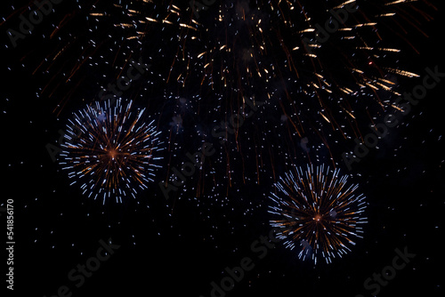 Huge explosions of purple, blue and red fireworks in the night sky. Beautiful fireworks against the dark sky. copy space, big fireworks background, holiday concept