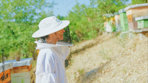 Profile of a female beekeeper in a field