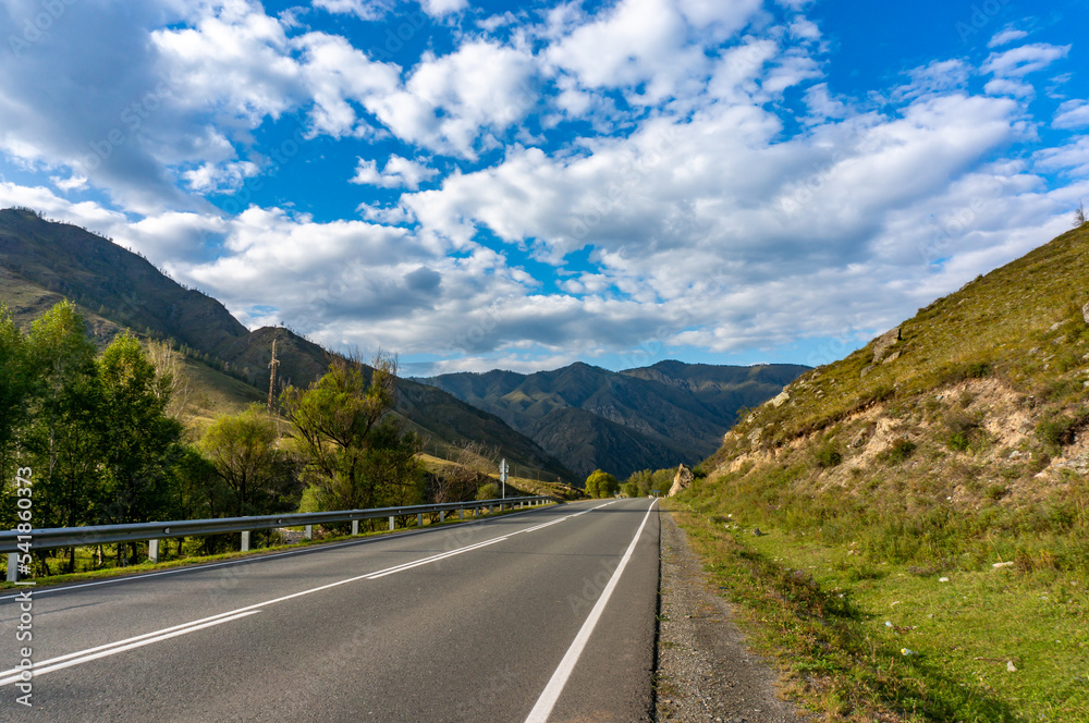 A road surrounded by mountains in the Altai Republic. Gorny Altai A road surrounded by mountains in the Altai Republic. Gorny Altai